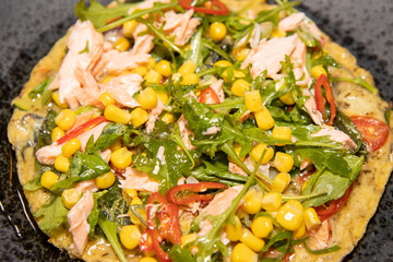 A plate of delicious salmon and sweetcorn frittata, served with a spring onion dressing.