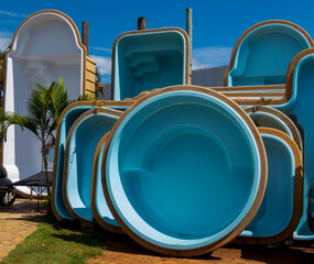blue and white fiberglass pools on display for sale