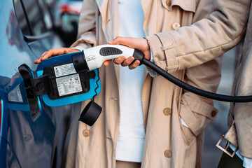 Friends refuel car in gas station. Close up view