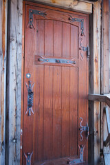 Wooden doors with metal forged inserts