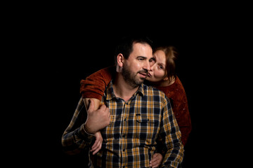 Middle-aged couple with attitude of love posing on a black studio background