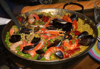 the traditional Valensian paella in the typical wrought iron pan