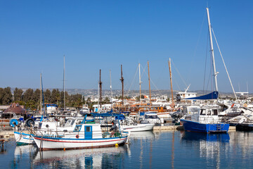 Fototapeta na wymiar Fishing boats in Paphos harbour Cyprus at the Mediterranean tourist resort, which is a popular travel destination attraction landmark, stock photo image 