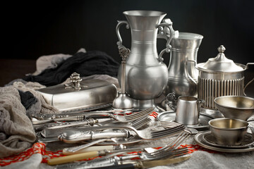Fototapeta na wymiar Silver dishes on old background