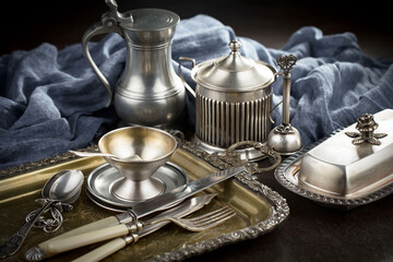 Silver dishes on old background