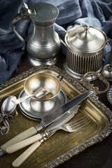 Obraz na płótnie Canvas Silver dishes on old background