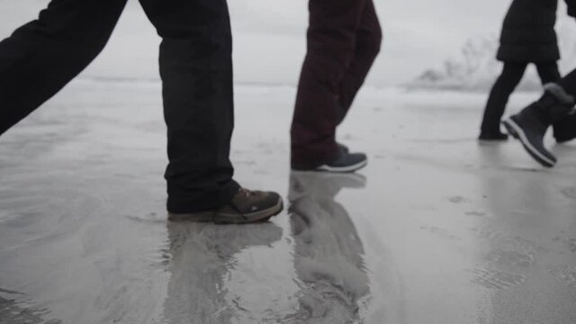 People walking by Norwegian coast in winter