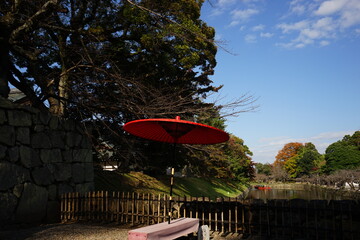 Castle Moat with Red Traditional Japanese Umbrella at Hikone Castle in Shiga, Japan - 日本 滋賀県 彦根城 お堀 赤い番傘