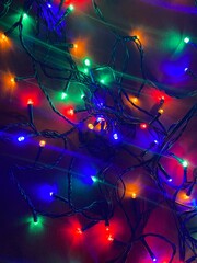 Fototapeta na wymiar Fesitve Christmas background with garland lights. New Year colorful abstract backdrop