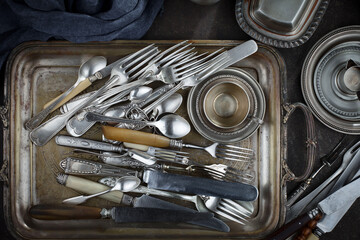 Silver dishes on old background
