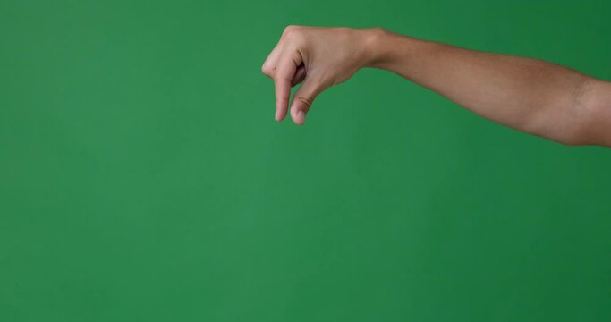 Hand grasping or picking up gesture over green background