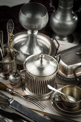 Silver dishes on old background