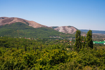 View on a green valley with mountain background