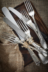Silver dishes on old background