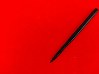 Copy space of Kajal pencil isolated on red background.