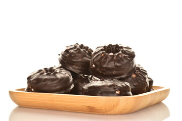 Delicious chocolate marshmallow on a bamboo plate, close-up, isolated on white.