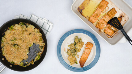 Baked salmon fillet served with vegetable casserole close up on a plate, view from above