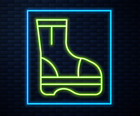 Glowing neon line Fire boots icon isolated on brick wall background. Vector.