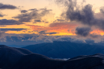 Fototapeta na wymiar Devil's Knob Overlook – Blue Ridge Mountains horizon with pink and yellow clouds at sunset