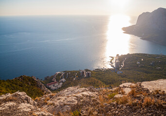 sunset view on a green valley and sea with mountain background