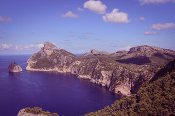 Mountain panorama view with blue sky, cumulus clouds and blue sea, ocean in Mallorca, Spain