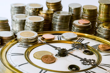 stack of coins on vintage clock