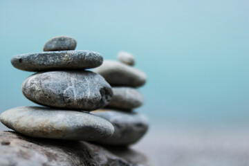 Fototapeta na wymiar Balance stone on lake coast. Symbol of relax
