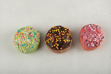 Colorful sweet small doughnuts on a white background