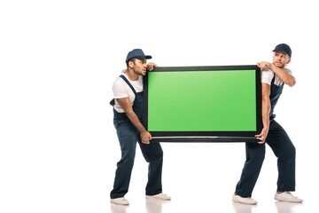 full length of multicultural movers stealing plasma tv with green screen on white