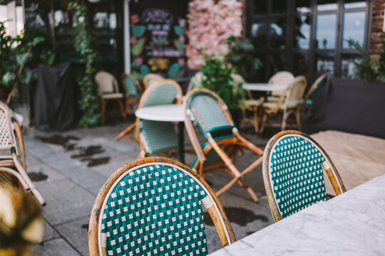 Green and wooden chairs in an outdoor restaurant in Oslo, Norway