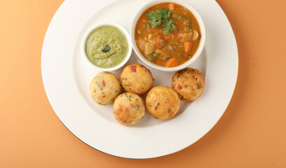 Kuzhi Paniyaram served with coconut chutney and sambar- South Indian breakfast