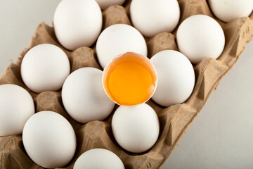 Raw chicken eggs in egg box on a white background