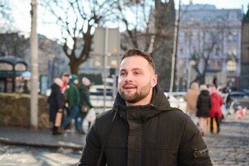 Attractive guy portrait in winter on the street