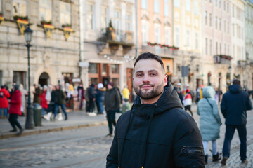 Attractive guy portrait in winter on the street