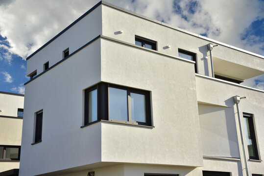 Edelstahl-Attika-Profilblech als Mauerschutz an Balkonen und Kasten-Dachrinnen mit verzinkten Wasserfangkästen an einer modernen Flachdach-Mehrfamilien-Wohnanlage