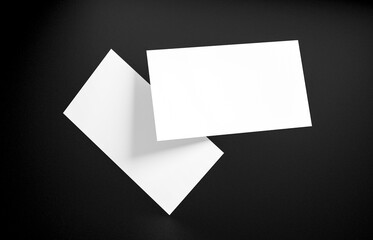 Floating Business Card Mockup. Closeup on two empty business cards floating in the air in front of the black background.