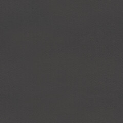 Seamless Black cardboard background with closeup on a piece of black colored paper.