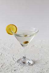 margarita cocktail in the bar. martini glass of cocktail with olives on white background. Glasses for martini with lemon on the table. copy space. alcohol drinks. vertical