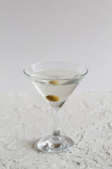 margarita cocktail in the bar. martini glass of cocktail with olives on white background. Glasses for martini on the table. copy space. alcohol drinks. vertical