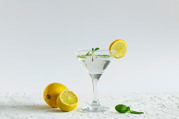margarita cocktail in the bar. martini glass of cocktail with green mint and olives on white...