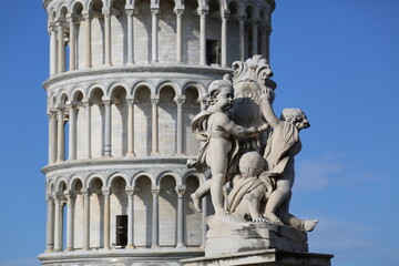leaning tower pisa on a sunny day with a statue
