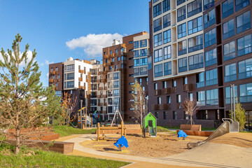 Playground for children and house building exterior mixed-use urban multi-family residential...