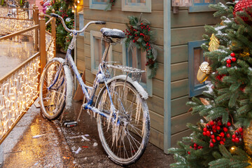 Fototapeta na wymiar Bike in icicles and snow ice at the winter house city road