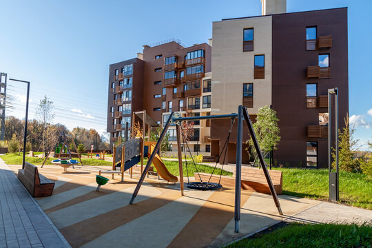 Modern house building with kids playground mixed-use urban multi-family residential district area development