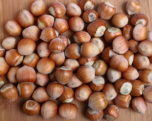 hazelnuts in shells on a wooden background