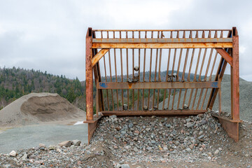 A rusty rock filter at a gravel pit. This type of filter is used to separate larger rocks from...