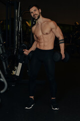 Obraz na płótnie Canvas Strong Guy is training in the gym.