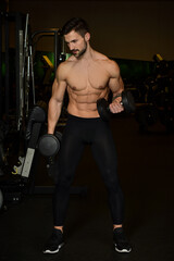 Fototapeta na wymiar Strong Guy is training in the gym.