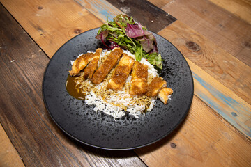A delicious plate of Katsu Chicken Curry with boiled rice, fried chicken dinner