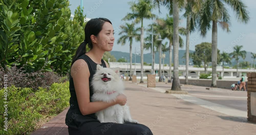 Wall mural Woman go out with her dog at park